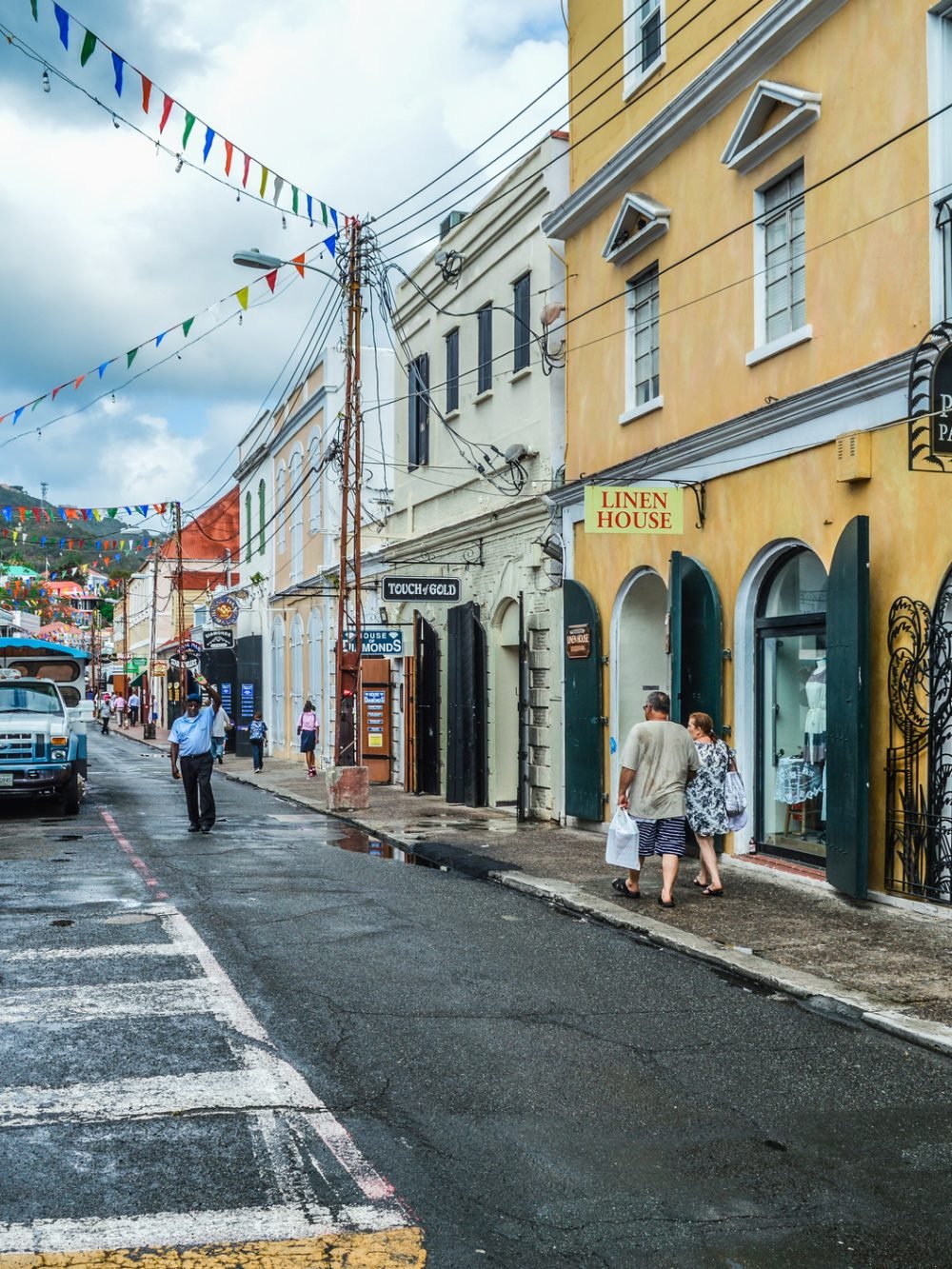 Charlotte Amalie, Virgin Islands - April 23, 2014: Old colonial architecture is prevalent all across the old part of Charlotte Amalie. Photo features colorful buildings, and also contains some pedestrian and vehicular activity.